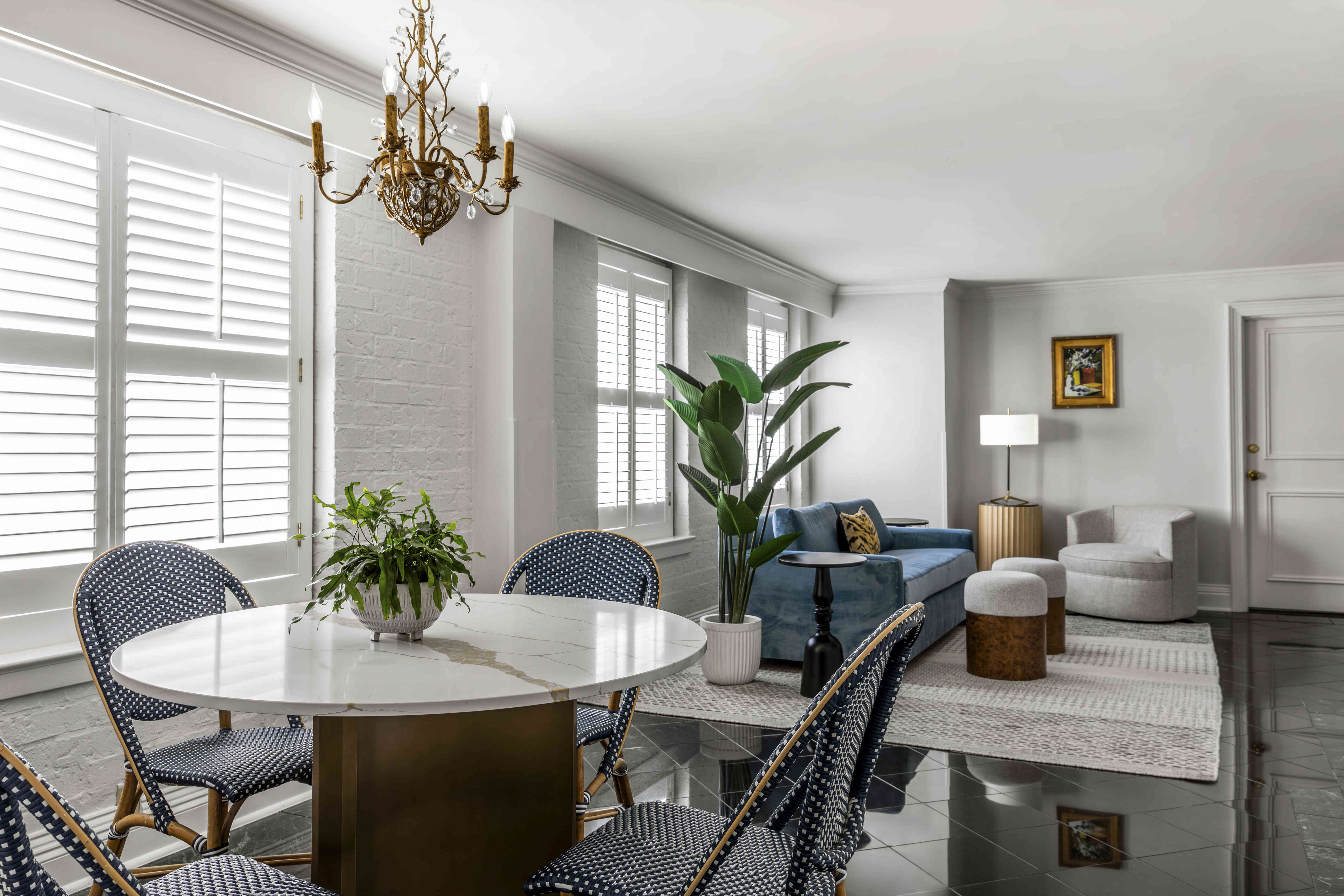 A brightly lit living room with a dining area and a sitting area.