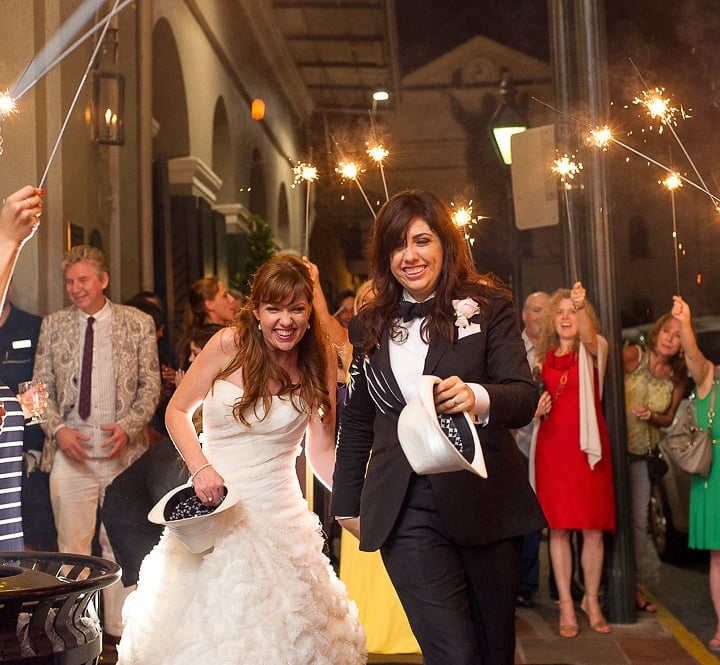A newly married couple being celebrated by sparklers