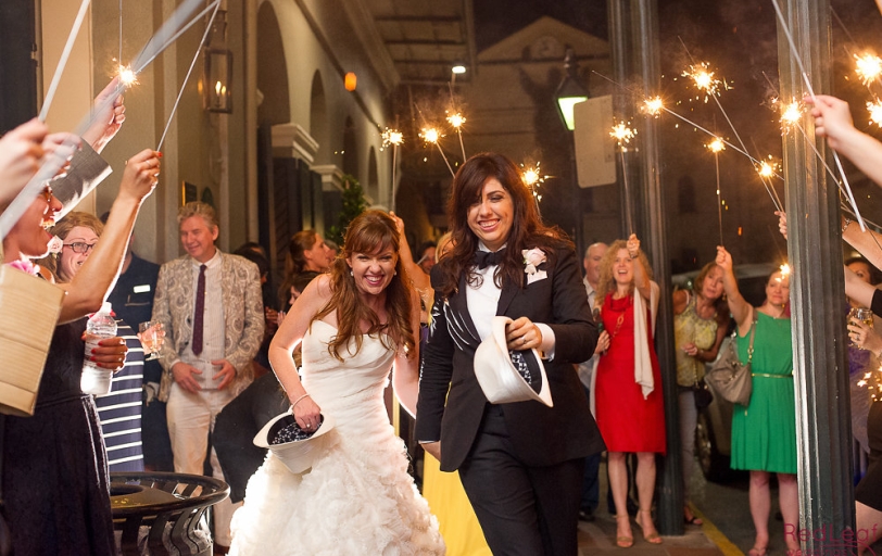 A newly married couple being celebrated by sparklers