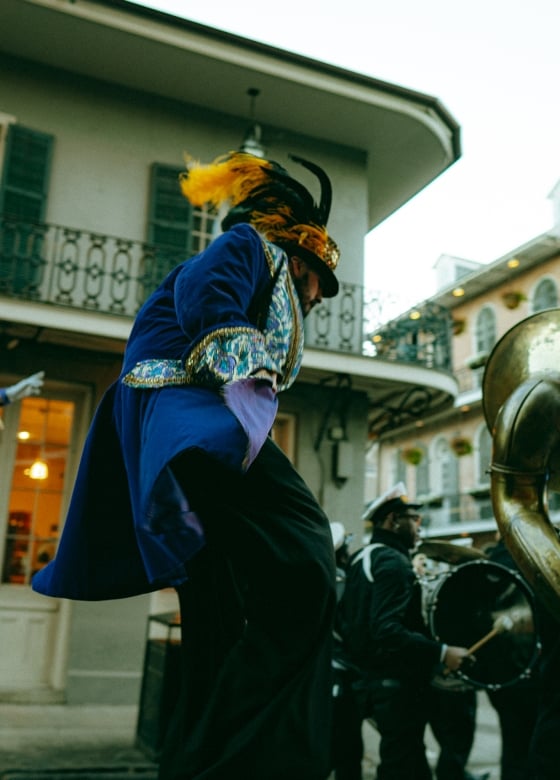 Man on stilts dressed in a Mardi Gras Costume