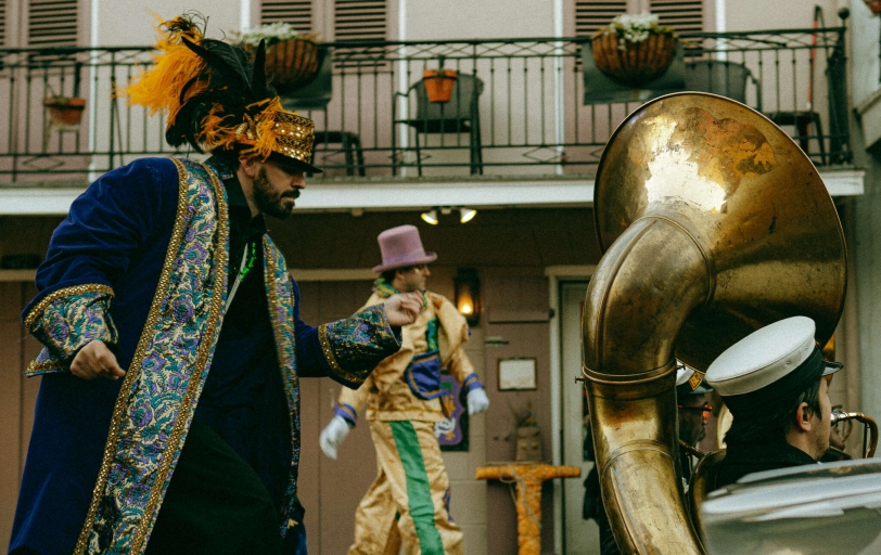 Man on Stilts Walking with Brass Band in Mardi Gras Attire